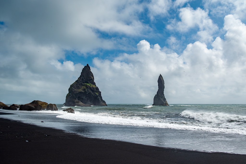 Sea stacks off the shore of Reynisfjara black sand beach in Iceland