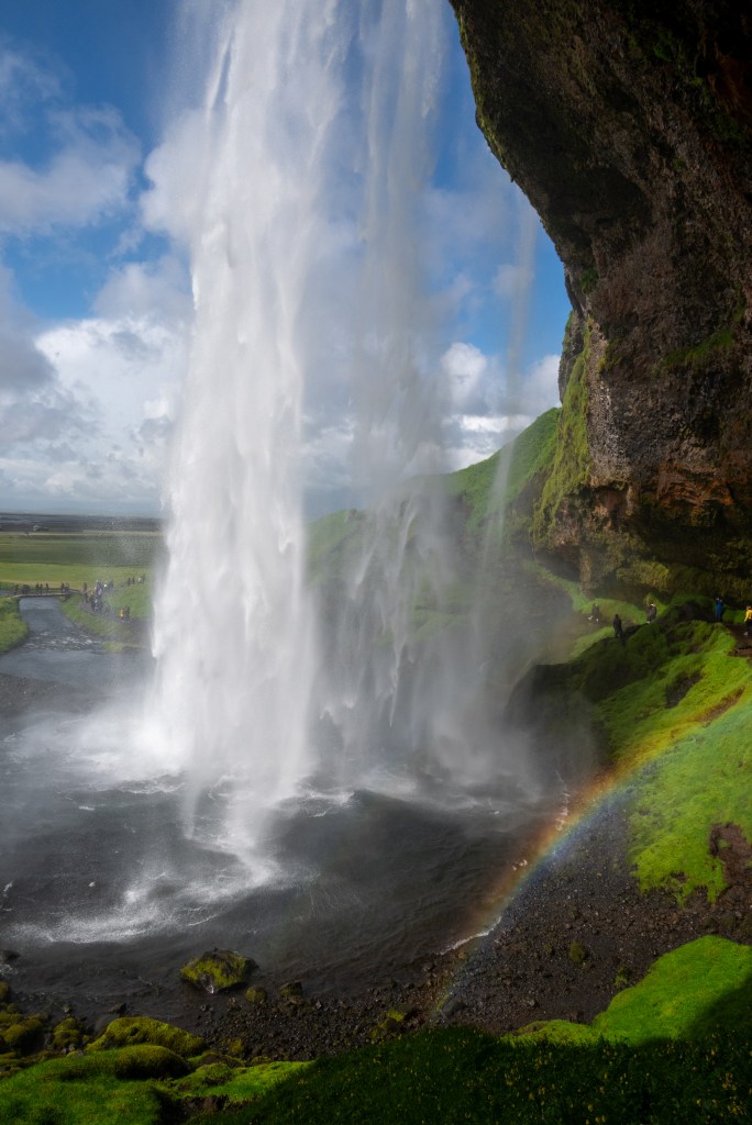 Behind Seljalandsfoss in Iceland on a sunny day