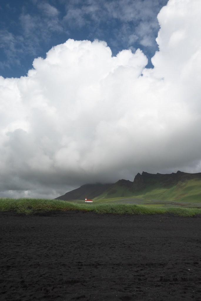 Reyniskirkja Church in Vik, Iceland from the black sand beach