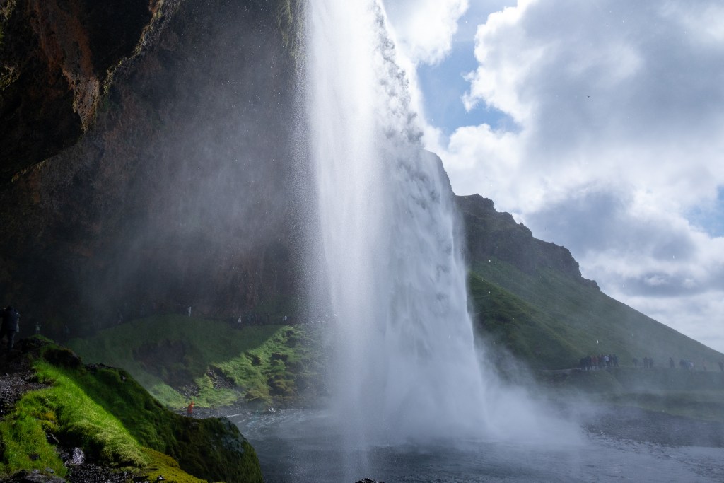 The side of Seljalandsfoss in Iceland on a sunny day